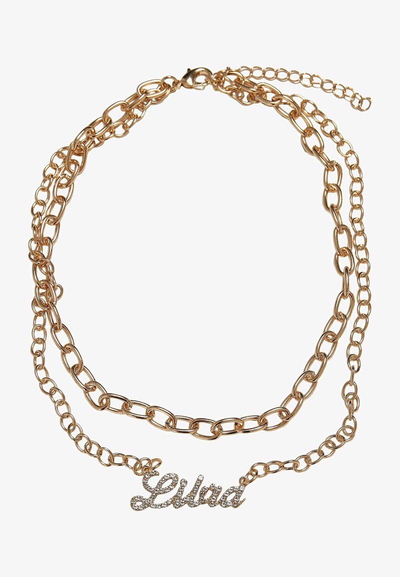 Zlatavý řetízkový náhrdelník s několika propojenými řetězy. Uprostřed je umístěno jméno "Lila" ve třpytivých kamínkách, které zvýrazňují detail jména.