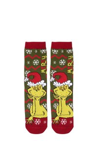 Calzetti verdi con un personaggio dei cartoni animati che indossa un cappello di Babbo Natale rosso. I motivi includono fiocchi di neve e design a zigzag in rosso e bianco.