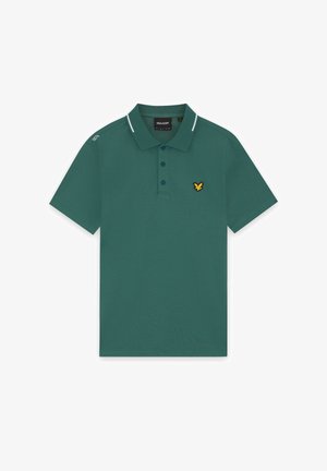 Polo vert à manches courtes avec patte de boutonnage, petit logo aigle jaune et noir sur la poitrine, et rayures blanches sur les bords du col et l'épaule.