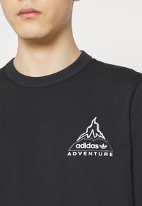 adidas Originals VOLCANO - Ilgarankovis viršutinės dalies drabužis - black