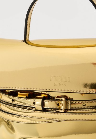 Χρυσή μεταλλική τσάντα Moschino Milano με χειρολαβή στην κορυφή και διακοσμητική λουρίδα με αγκράφα.
