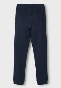 Marineblauwe katoenen leggings met een rekbare tailleband en een aangesloten pasvorm. Glad materiaal zonder zichtbare patronen of hardware-details.