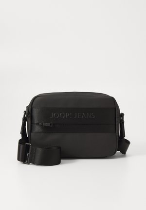 Black rectangular crossbody bag with a smooth texture, zip closure, adjustable strap, and embossed "JOOP! JEANS" logo at the front.