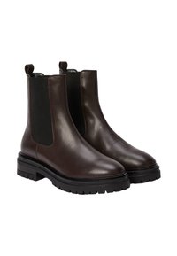 Bottines chelsea en cuir marron avec des panneaux élastiques sur les côtés, bouts arrondis et semelles épaisses en caoutchouc noir. Comprend des languettes pour un enfilage facile.
