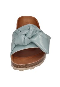 Light blue patent slide sandal featuring a twisted knot design, a brown cushioned insole, and a textured cork-like outsole.