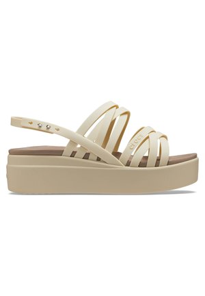Crème gekleurde platform sandalen met meerdere dunne banden, een gladde bovenkant en een gestructureerde zool; heeft een verstelbare enkelband met metalen accenten.