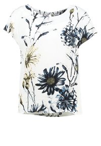 Top bianco con stampe floreali blu e gialle, maniche corte, vestibilità ampia e scollatura rotonda. Tessuto leggero e morbido con una sottile trama.