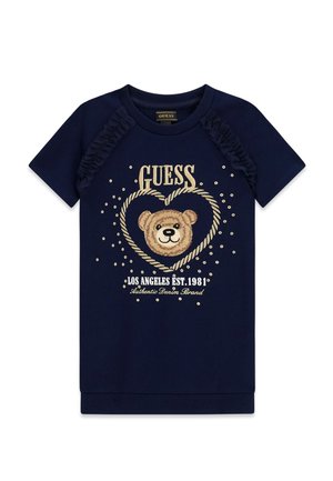 Granatowa koszula z krótkim rękawem z falbankami na ramionach, grafiką z twarzą misia w sercu oraz napisem "GUESS Los Angeles EST. 1981" z przodu.