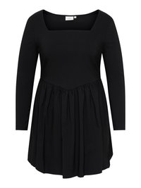 Svart kjole med lange ermer, firkantet utringning og innsvingt midje som skaper et utsvingt skjørt.