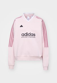 Roze Adidas sweatshirt met lange mouwen, een opstaande kraag en drie roze strepen langs elke mouw. Beschikt over een zwart logo en een gestructureerde stof.