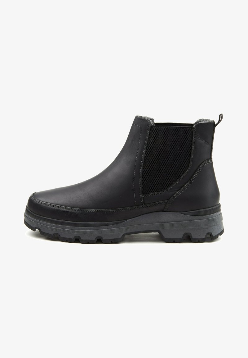 Bottette noire en cuir avec panneau latéral élastique, semelle épaisse à relief et languette à l'arrière, conçue pour la durabilité et le confort.