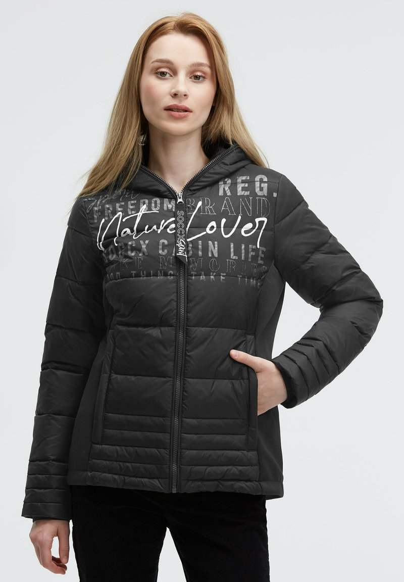 Black puffer jacket with a front zipper, quilted texture, and hood. Features "Nature Lover" text and multiple graphic accents.