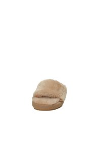 Pantofole in pelle di pecora beige con forma arrotondata, upper in morbido tessuto e suola in gomma piatta. Il design presenta un'apertura ampia e soffice.