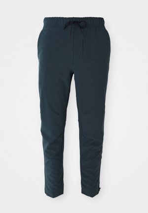 Dark blue jogger pants made of lightweight fabric, featuring an elastic waistband with drawstring and tapering towards the ankles.