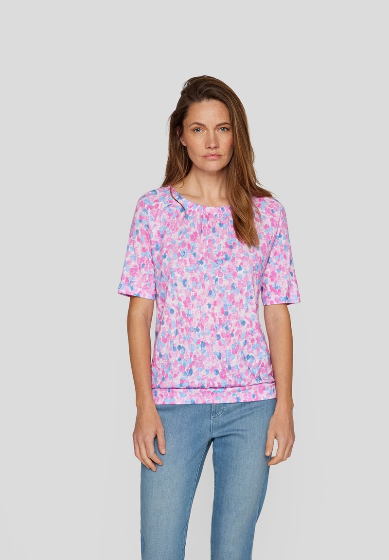 Short-sleeve top in pink with a speckled pattern in shades of blue and purple. Features a round neckline and relaxed fit. Soft fabric.