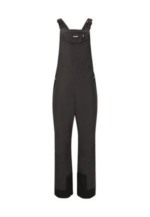 Salopettes noires imperméables avec des bretelles réglables, poche avant, zips latéraux et accents noirs renforcés aux poignets. Fabriquées en tissu durable.
