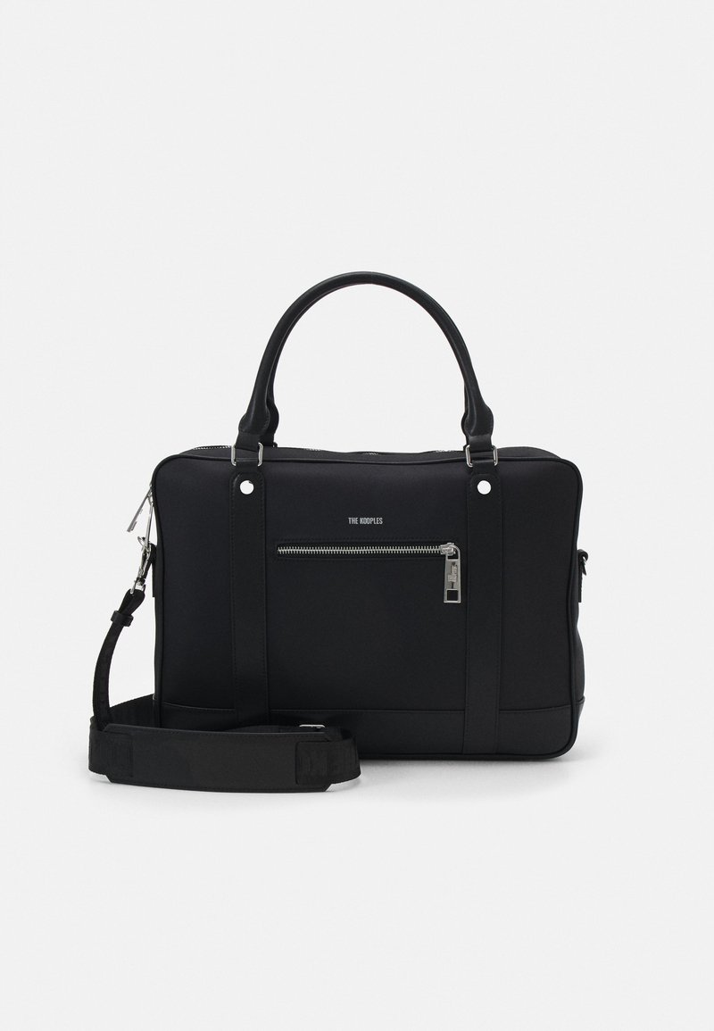 Black synthetic tote bag with two handles, a detachable shoulder strap, front zippered pocket, and silver hardware accents.