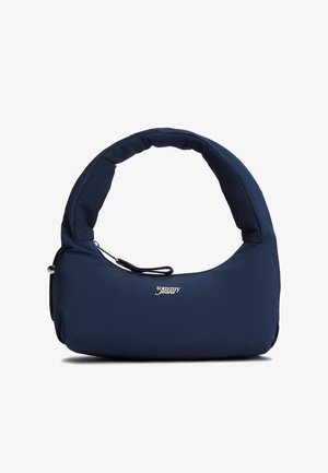 Τσάντα ώμου σε σκούρο μπλε ναυτικό χρώμα με μαλακό επένδυση, κυρτή λαβή και εμπρόσθια τσέπη με φερμουάρ, με λευκό λογότυπο "tommy jeans" στο κέντρο μπροστά.