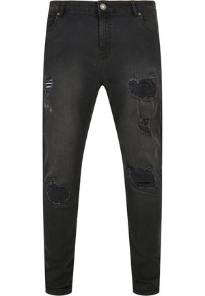 Černé džíny z denimu s úzkým střihem, které obsahují opotřebované detaily, trhliny a vybledlé oblasti. Standardní pětivreckový design s kovovým zapínáním.