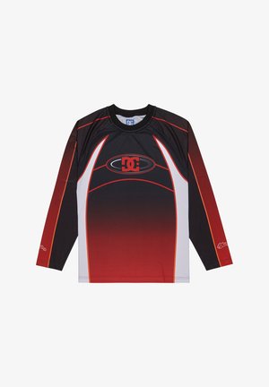 Maglia sportiva a maniche lunghe nera, rossa e bianca con logo DC centrato e motivo a punti gradienti sul davanti e sulle maniche.