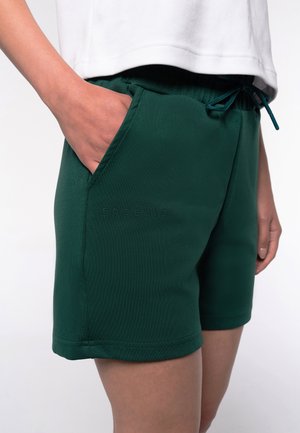 Green shorts made of smooth fabric, featuring an elastic waistband, drawstring, and side pockets. "EOSILIO" logo is embossed on the front.