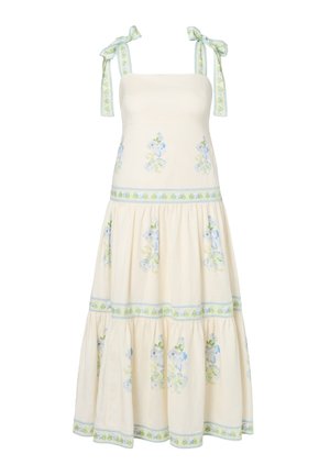 Robe longue crème à imprimés floraux bleus et verts, dotée d'une jupe à volants et de liens aux épaules avec le même motif floral.