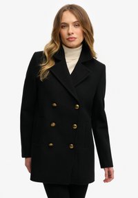 Zwarte dubbelrijige jas van textuurstof met gouden knopen, een brede kraag en zijzakken, ontworpen voor een aansluitende pasvorm.