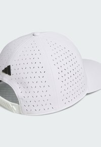 Hvid kasket med perforeret design for ventilation, med en buet skygge og sort logo på siden. Fremstillet af letvægtsstof med justerbar bagside.