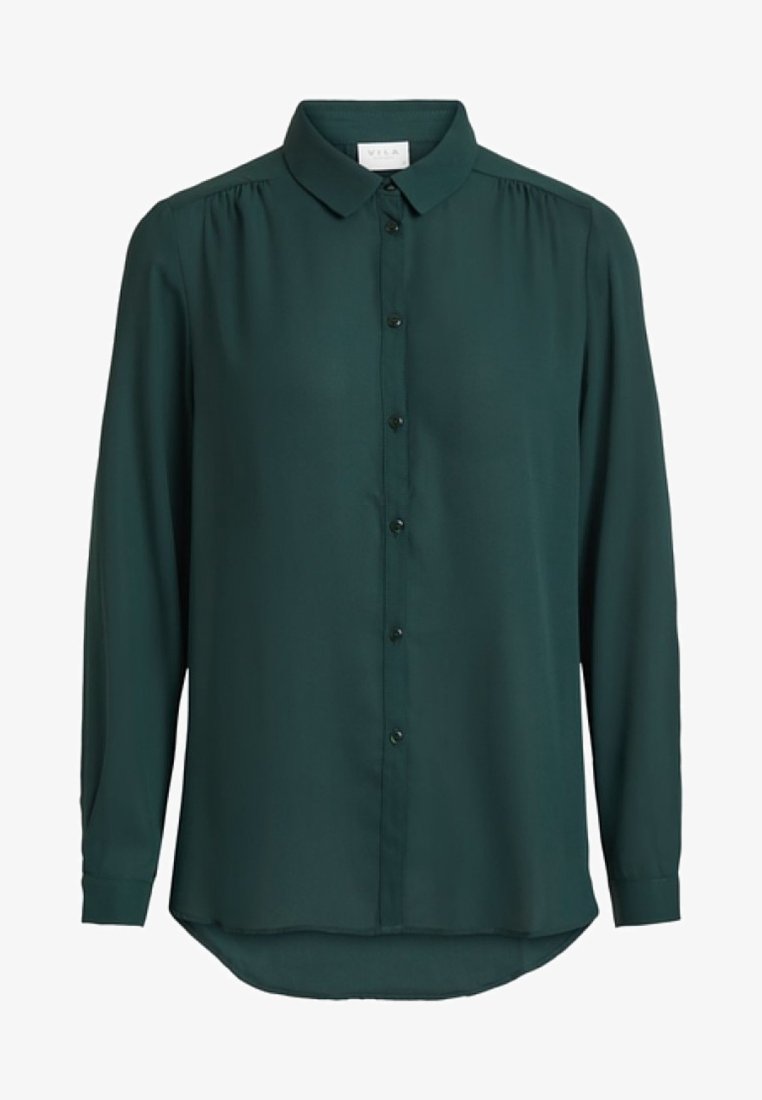 Chemise vert foncé à manches longues, boutonnée, avec col et légers fronces aux épaules.