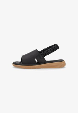 Sandalia negra de punta abierta con correa trasera elástica y suela acolchada color marrón claro, diseñada para comodidad casual y fácil uso.