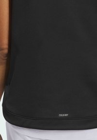 Black athletic top with a smooth, stretchy texture and a rounded hem. Features "COLD.RDY" branding on the lower back.