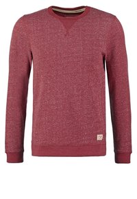 Czerwona bluza z teksturowanej tkaniny, z długimi rękawami, prążkowanymi mankietami i dekoltem. Na dolnej części przodu znajduje się mała naszywka z logo.