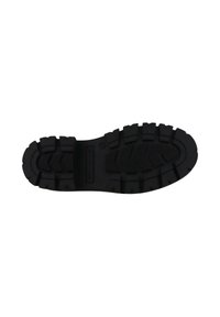 Suela de zapato de goma negra con un patrón de surcos profundos y múltiples tacos de tracción. Presenta un área lisa y plana en el centro y marca lateral.