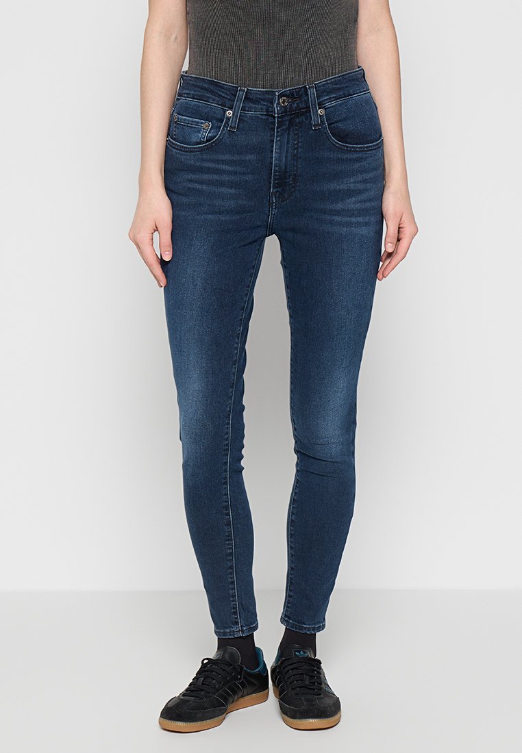 Dunkelblaue Skinny Jeans aus Denim, mit Fronttaschen, einem Reißverschluss mit Knopfverschluss und einer schmalen Passform durch die Beine.