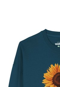 Teal katoenen sweatshirt met een grote zonnebloemafbeelding; ronde hals, verlaagde schouders en een zachte textuur.