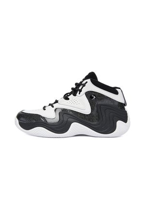 Sneaker alta bianca e nera con motivo ondulato sulla suola e lacci neri, vista di lato su sfondo bianco.