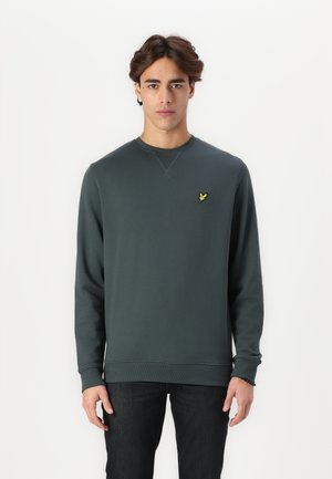 Sudadera de manga larga verde oscuro con cuello redondo, puños y dobladillo acanalados. Presenta un pequeño logotipo de un pájaro amarillo en el lado izquierdo del pecho.