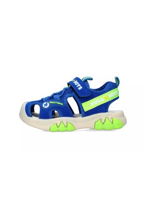 Infradito blu da esterno con tomaia in mesh traspirante, cinturino regolabile e dettagli verde brillante. Suola strutturata con finiture in gomma antiscivolo.