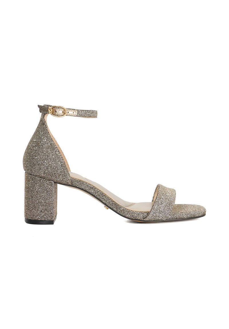 Glittery gold block-heel sandal with a wide strap across the toe and adjustable ankle strap; textured fabric and smooth sole.