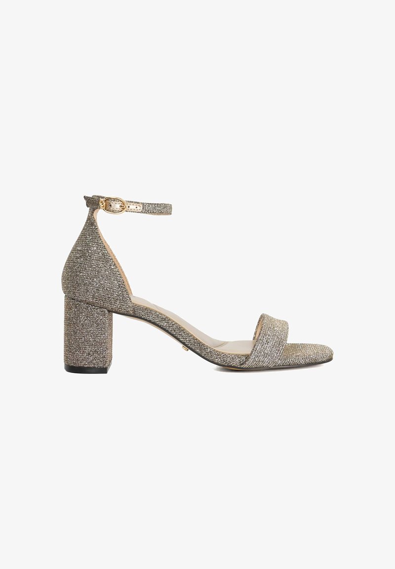 Glittery gold block-heel sandal with a wide strap across the toe and adjustable ankle strap; textured fabric and smooth sole.