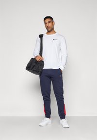 Champion RETRO SPORT CUFF PANTS - Pantalones deportivos - dark blue