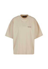 Beige oversized t-skjorte med korte ermer og liten "PEGADOR" tekstlogo øverst til venstre på brystet.