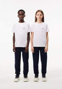 Lacoste CORE PANT UNISEX - Tracksuit bottoms - marine