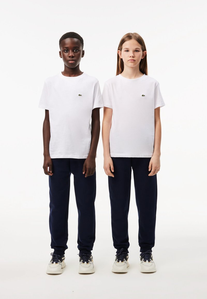 Lacoste CORE PANT UNISEX - Tracksuit bottoms - marine