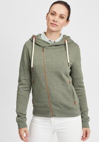 Green zip-up hoodie with a soft texture, featuring a front zipper, drawstring hood, and brown triangular accents on the sides.