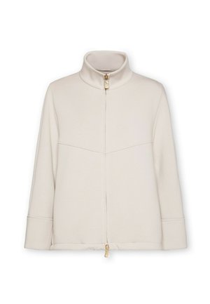 Veste en polaire beige avec un col montant, fermeture éclair à l'avant et manches longues. Présente des détails de coutures et un accent de fermeture éclair dorée.