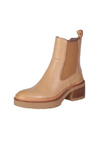 Stivale alla caviglia in pelle beige con pannelli laterali elastici, tacco spesso e dettaglio rigato sulla suola. Presenta un loop decorativo sul retro.