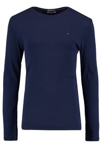 Marinblå långärmad t-shirt i bomull, med rund halsringning, sydda muddarna och en liten logodetalj på bröstet.