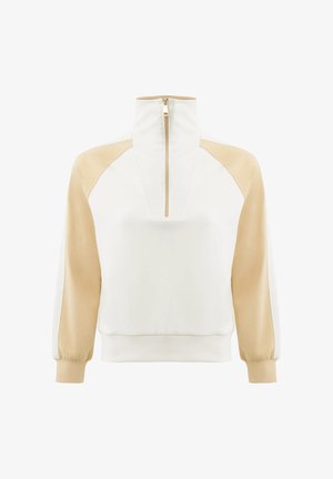 Pull-over à manches longues blanc et beige avec col montant et fermeture éclair à l'avant, comprenant des manches raglan beige et des poignets.