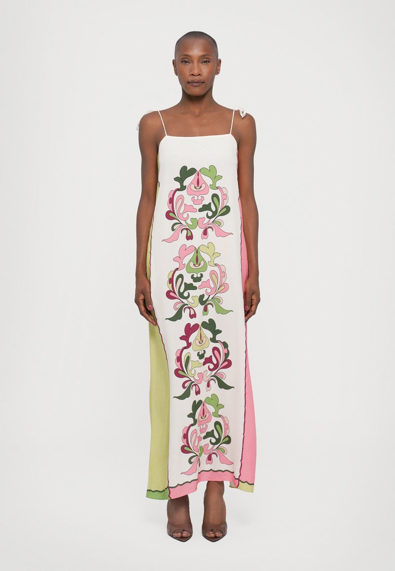 Maxi dress with thin straps, featuring a floral pattern in pink, green, and white. Smooth fabric with a side panel design.